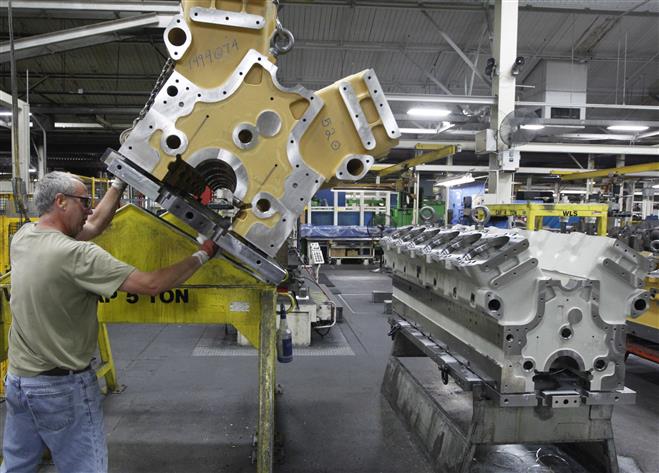 John Schubert wipes a crankcase to a natural gas-fueled engine Tuesday at GE Energy Waukesha, 1101 W. St. Paul Ave. GE Healthcare also said this week that it is committing more than $3 million to the University of Wisconsin-Milwaukee.