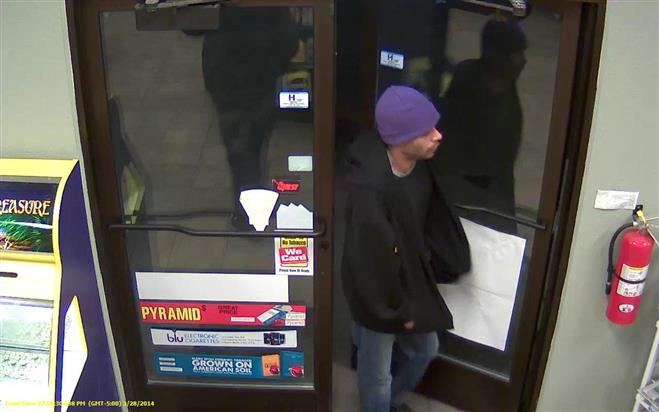 A second robbery suspect is seen entering the BP gas station store.