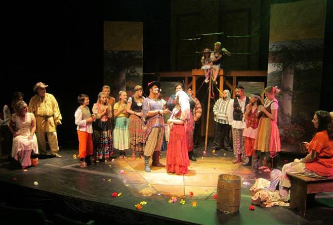 Petruchio and Katherine (Adam Qutaishat and Kassandra Novell) are surrounded by friends and family during the finale of “Taming of the Shrew” in a scene from UW-Waukesha’s “Kiss Me, Kate.” Petruchio and Katherine (Adam Qutaishat and Kassandra Novell) are surrounded by friends and family during the finale of “Taming of the Shrew” in a scene from UW-Waukesha’s “Kiss Me, Kate.”