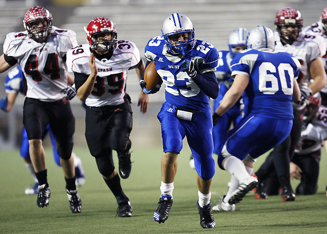 Waukesha West's Joe Schobert breaks away from Stevens Point defenders for a big gain during the WIAA Division 1 championship game Friday. Waukesha West won, 45-26.